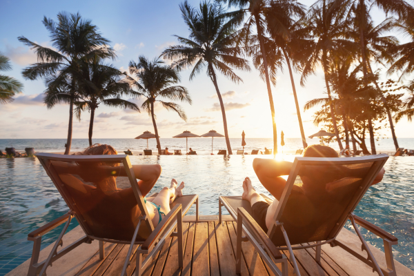 Image of 2 people on sun loungers 