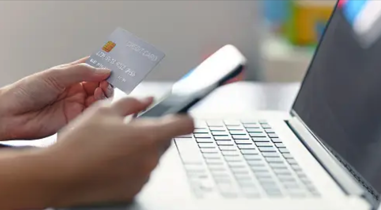 Online shopping using credit card at a laptop 